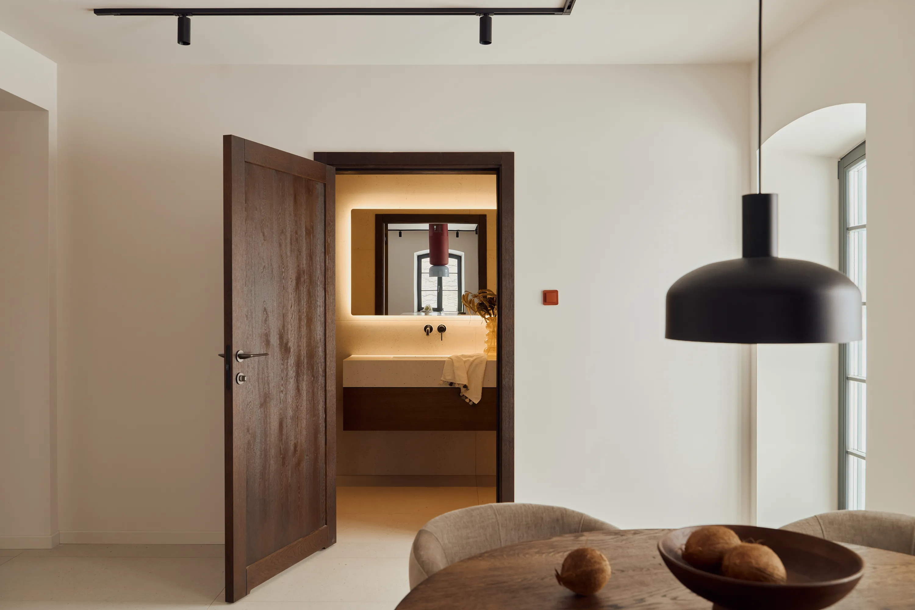 Walnut kitchen island with warm materiality and brass detailing