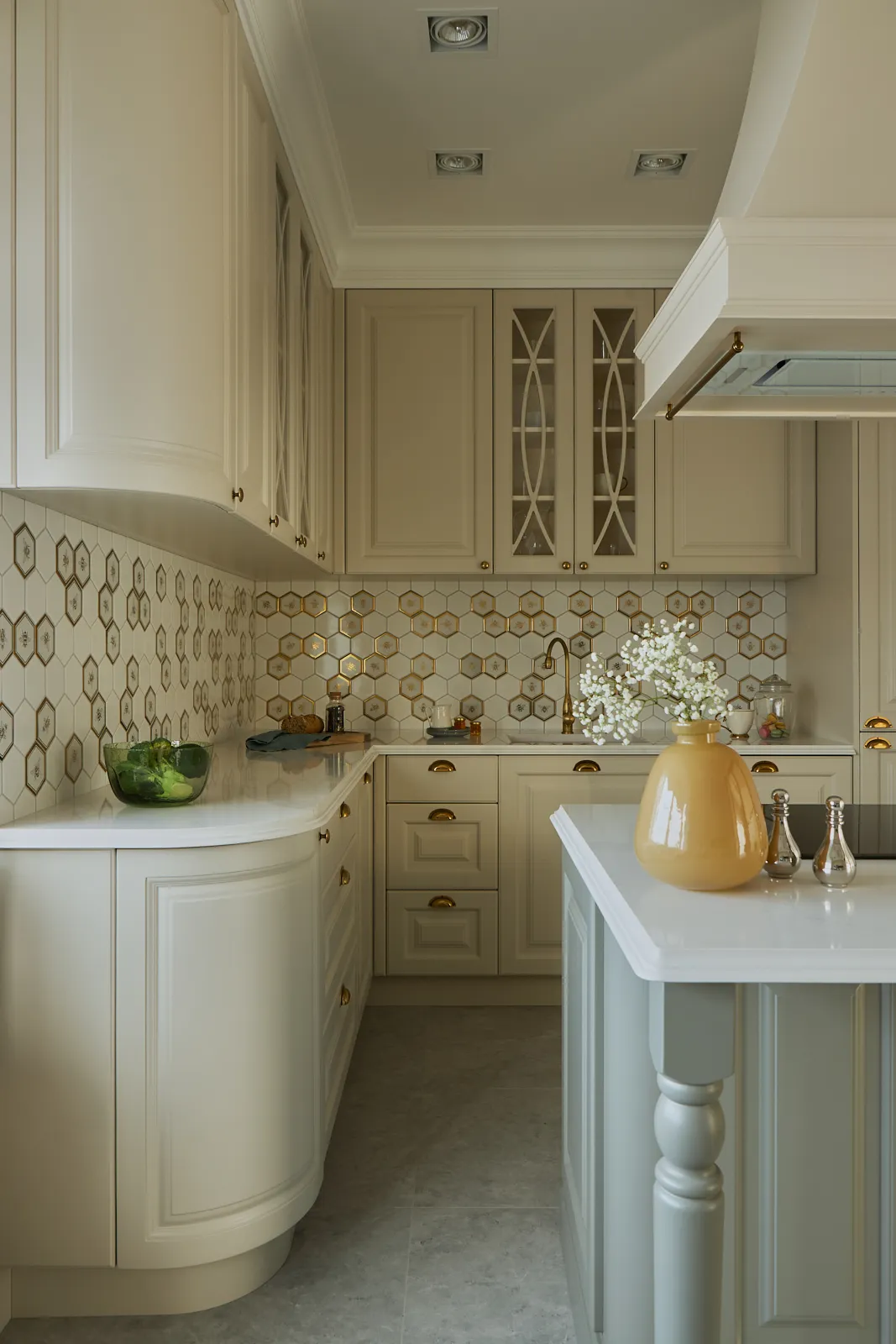 Traditional European kitchen with brass hardware and decorative glass mullions
